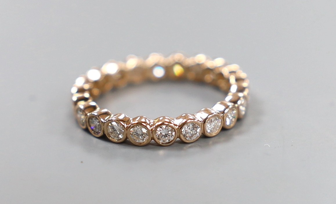 A yellow metal and diamond set full eternity ring, size N, gross weight 2.4 grams.
